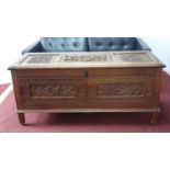 A late 19th/early 20th century carved oak coffer, H.64 W.140 D.52cm