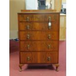 An Art Deco walnut chest of five drawers, quarter veneered top, on cabriole feet, H.117 W.76 D.48cm