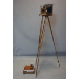 A Victorian field camera with tripod, negative holders and printing device, lens loose from camera