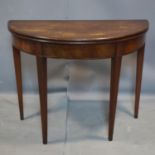 A George III mahogany demi lume fold over tea table, raised on tapered legs, H.72 W.90 D.90cm