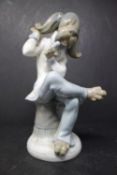 A Lladro model of a dog musician, H.20cm