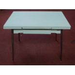 A vintage 1960's French Supermatic ?Le Tubmenager' extending dining table by Brevet, with formica