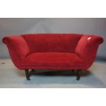 An early 19th century sofa recently upholstered in a red velour, raised on tapered mahogany legs and