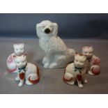 A Staffordshire dog, H.33cm, together with four Staffordshire cats, H.20cm (5)