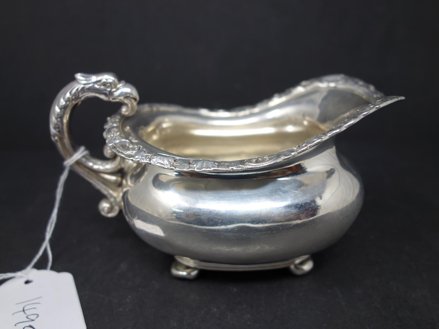 A silver cream jug with twin dragon head handles and shell and flower rims, hallmarked London, - Image 3 of 5