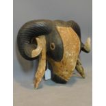 An African tribal mask in the form of a Ram's head, H.33 W.38cm