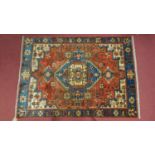 A Northwest Persian Nahawand rug, central diamond medallion with repeating petal motifs on a