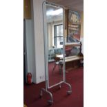 A large double sided Industrial cheval mirror, raised on castors, H.229 W.70cm