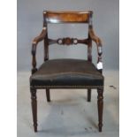 A Georgian mahogany elbow chair with stuff-over seat, on turned legs, H.81cm