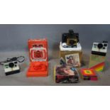 Three vintage polarioid cameras to include a colour swinger land camera and two 1000 land cameras,