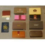 Four boxed purses, a boxed cigarette case and a UK passport wallet