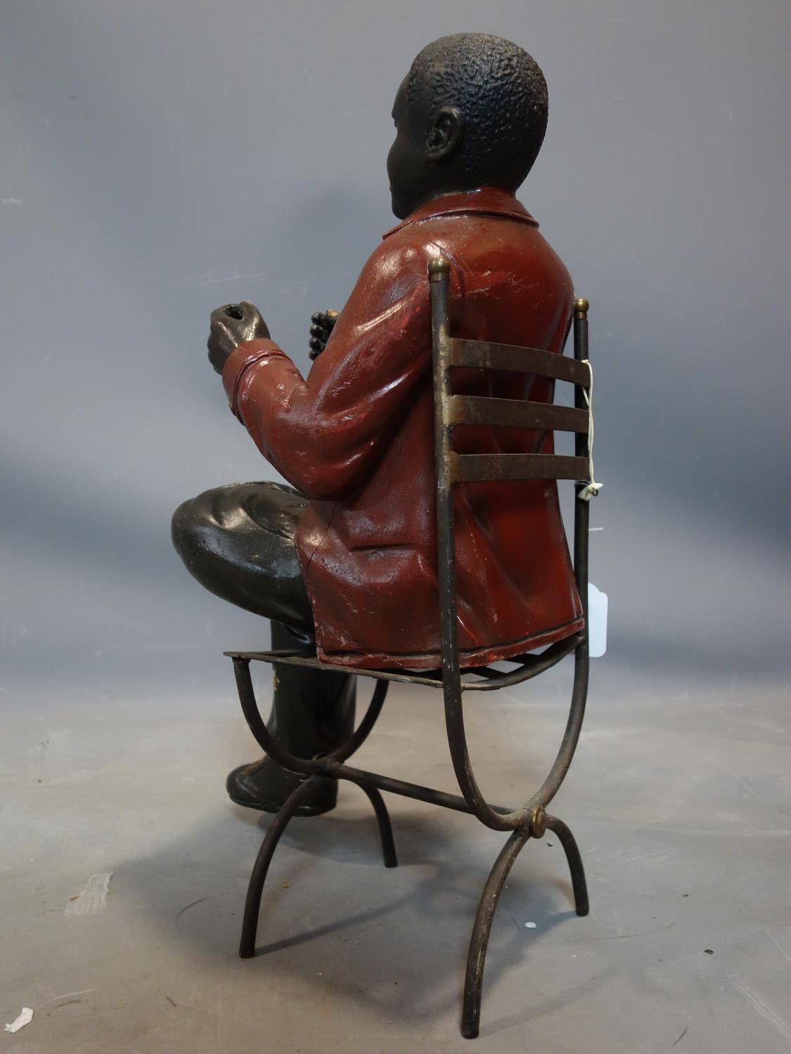 A fibreglass figure of a seated man, on a metal chair, H.55cm (man), H.43cm (chair) - Image 3 of 3