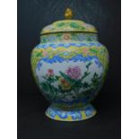 A Chinese enamel jar and cover, decorated with vignettes of birds and flowers within a yellow ground