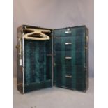 A vintage travelling wardrobe, the faux crocodile skin interior with wardrobe and four drawers, H.
