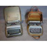 Two vintage Blue Bird typewriters with travel cases