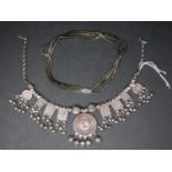 A white metal necklace together with a three strand beaded necklace, the clasp stamped 750 (2)