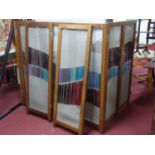 A vintage 8 fold oak dressing screen, with wire mesh and glass panels, H.144 W.400cm
