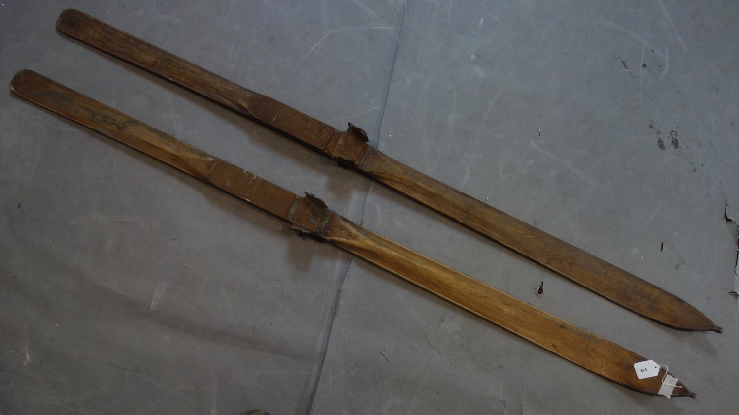 A pair of vintage oak skis inlcuding ski poles by Faucigny J. Amoudruz