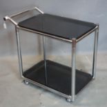 A vintage chrome 2 tier drinks trolley, with smokey glass shelves, raised on castors, H.75 W.80 D.