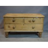 A 20th century pine low chest of three drawers, raised on turned legs, H.55 W.95 D.45cm