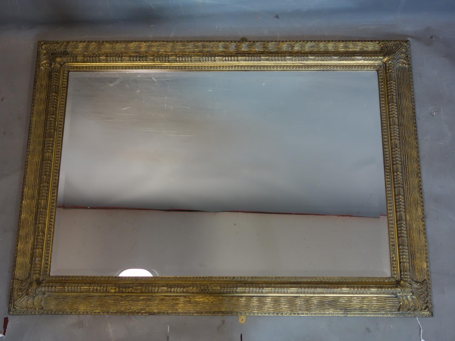 A large contemporary gilt framed mirror with bevelled plate, 112 x 80cm