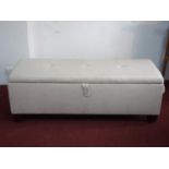 A contemporary linen upholstered ottoman stool, with hinged compartment, H.50 W.138 D.52cm