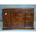A 19th century mahogany low chest of drawers, with an arrangement of 12 drawers on a plinth base,