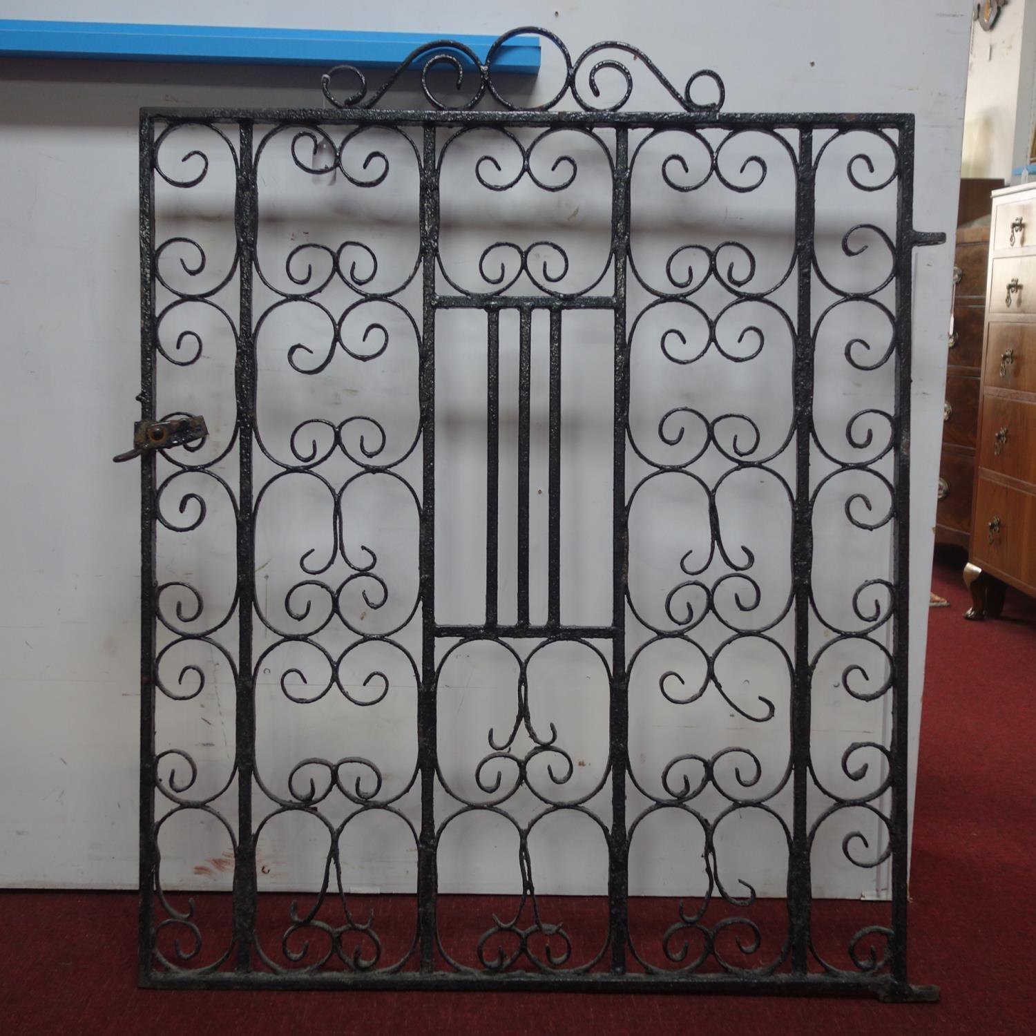 A vintage black painted wrought iron gate, 115 x 90cm