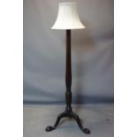 A Regency style mahogany standard lamp, with reeded and floral support on ball and claw feet, H.