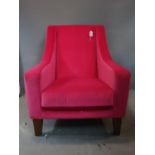 A contemporary armchair upholstered in a pink velour, raised on tapered legs, H.87 W.71cm