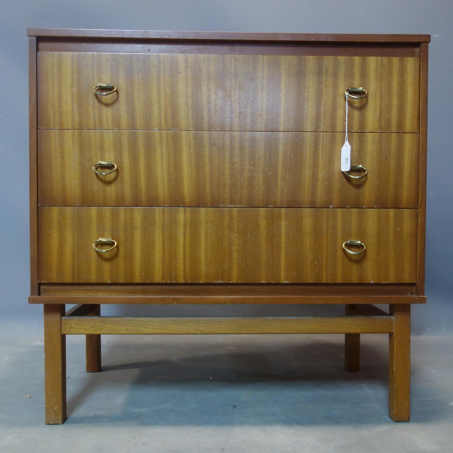 A mid 20th century teak chest of three drawers, raised on square legs, H.77 W.76 D.42cm