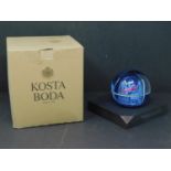 A Kosta Boda glass paperweight, boxed