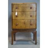 An Art Deco burr walnut side chest of drawers, with Bakelite handles, H.76 W.45 D.38cm