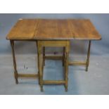 An early 20th century oak drop leaf table, H.76 W.103 D.76cm