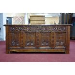 A 17th century oak coffer of panelled construction, with fitted candle box, the front carved with