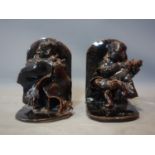A pair of glazed Judaic bookends, one modelled as a violinist and the other as a man holding