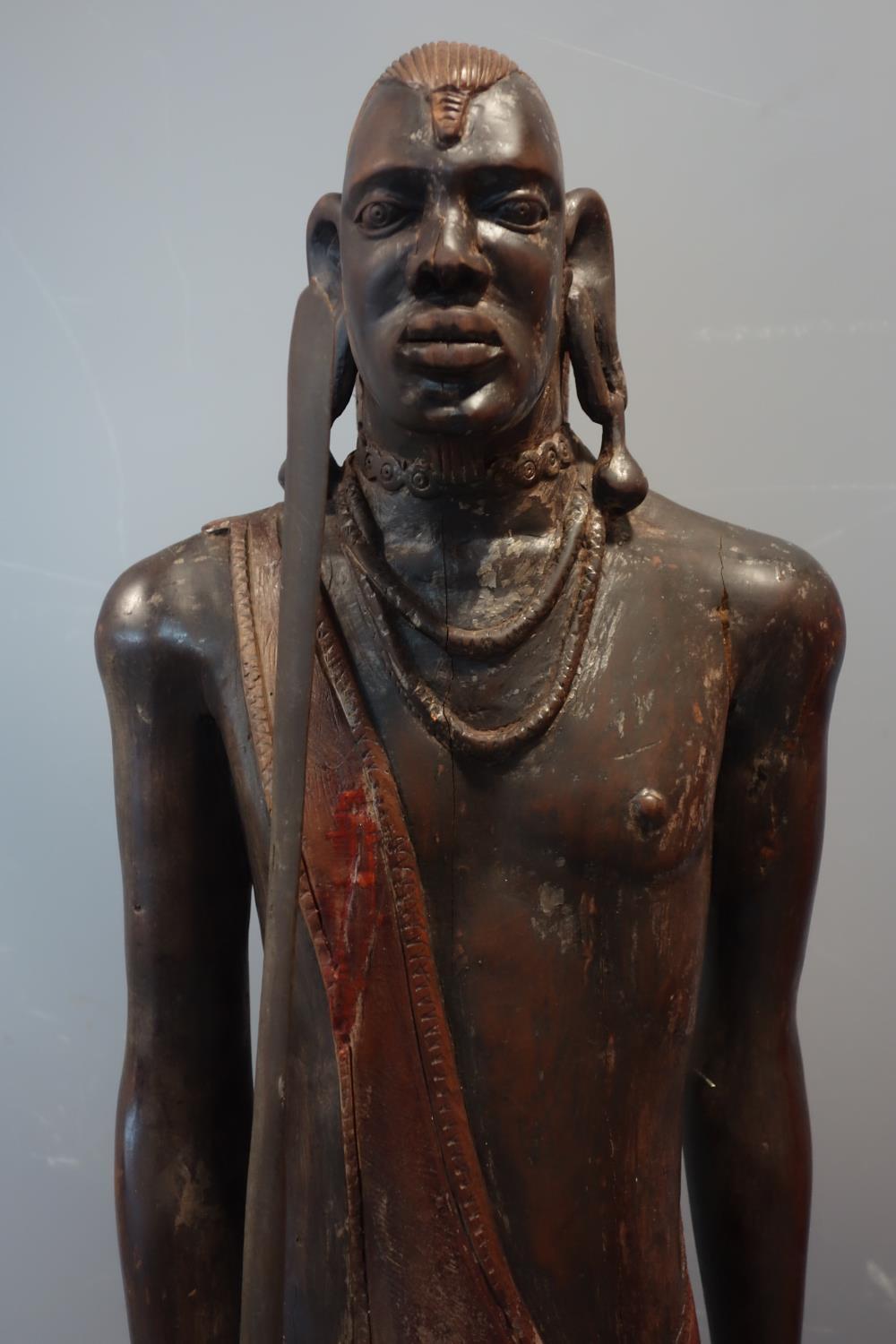 An African wooden carving of a Maasai warrior, carrying wooden spear and with shield (shield - Image 2 of 4