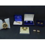 A collection of cufflinks, together with a clip and a watch