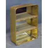 A contemporary gilt metal wall hanging book shelf, H.68 W.50 D.18cm