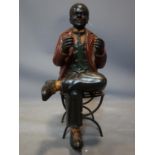 A fibreglass figure of a seated man, on a metal chair, H.55cm (man), H.43cm (chair)