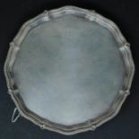 WITHDRAWN- A silver tray with gadrooned edge on ball and claw feet. hallmarks rubbed. D.20cm - 334g