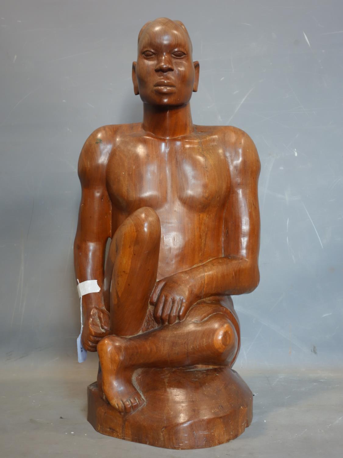 An African hardwood carving of a man, H.77cm