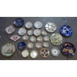 A large collection of Oriental plates, dishes, side plates, cups and saucers, and a cloisonne plate,