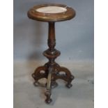 A Victorian oak Gothic occasional table with marble top, on reeded and turned support and three legs