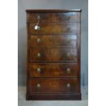 A 19th century inlaid mahogany tall chest of six graduating drawers, with lion paw handles, on a