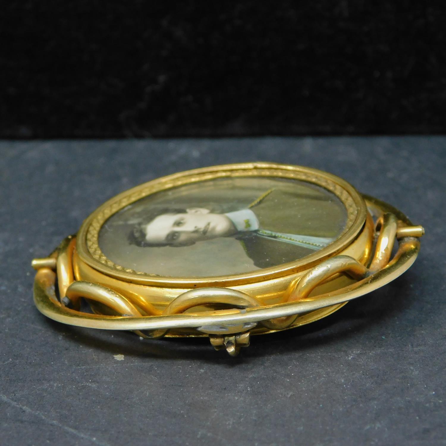 A 19th century pinchbeck brooch with double sided revolving picture frame, H.6cm, in associated box - Image 3 of 4