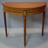 An Empire style inlaid mahogany demi lune card table, on reeded legs with brass caps, 81 x 90cm