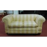 A late 19th/early 20th century drop end club sofa, raised on turned legs and castors, H.79 W.158 D.