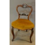 A Victorian mahogany dining chair, carved and shaped back on cabriole supports. H.85cm