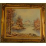 A gilt framed oil on board, mountains and lake to foreground. H.66 W.75cm